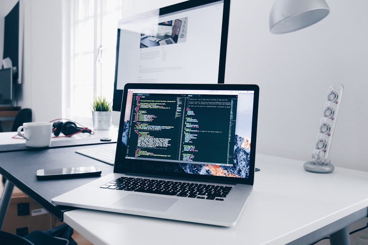 Developer laptop with code on screen for custom web development